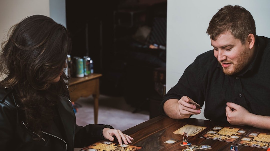 Two friends playing a cooperative tabletop game together