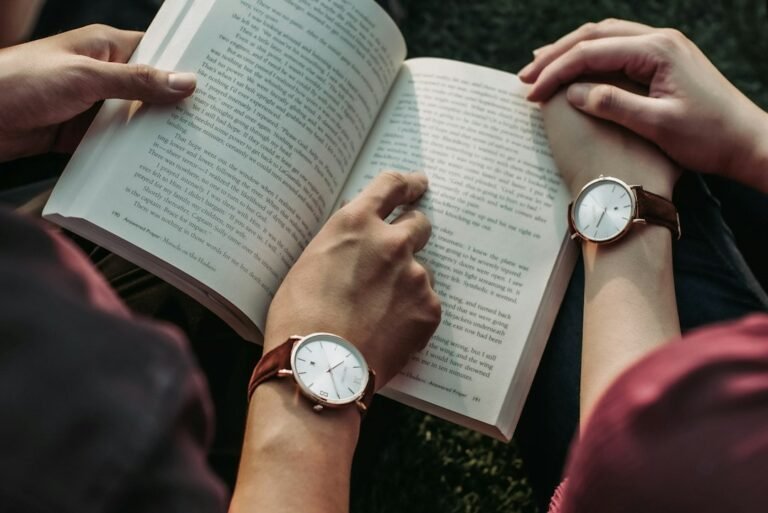Two people reading books together in a quiet shared reading setting